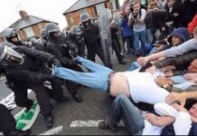 Riot Police and Protestors Come Together to Help Fat Man out of Jeans