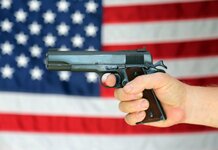 Gun held in front of American flag