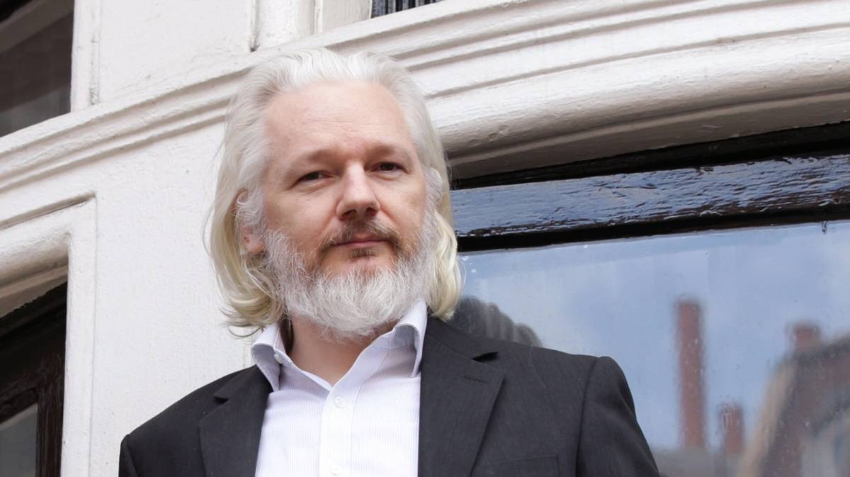 Julian Assange makes the most of the hot weather by opening a window