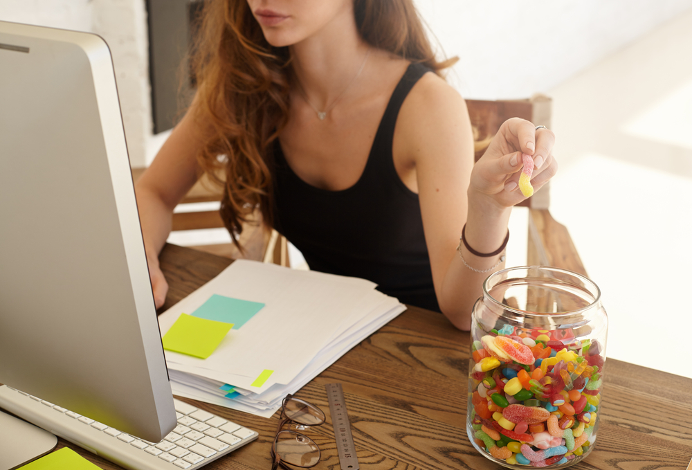 Disgraceful mum eats way through another giant tub of Haribo before Trick or Treaters arrive Woman eating sweets
