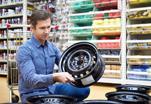 I suppose we better start our Christmas shopping, say men Man buying a wheel